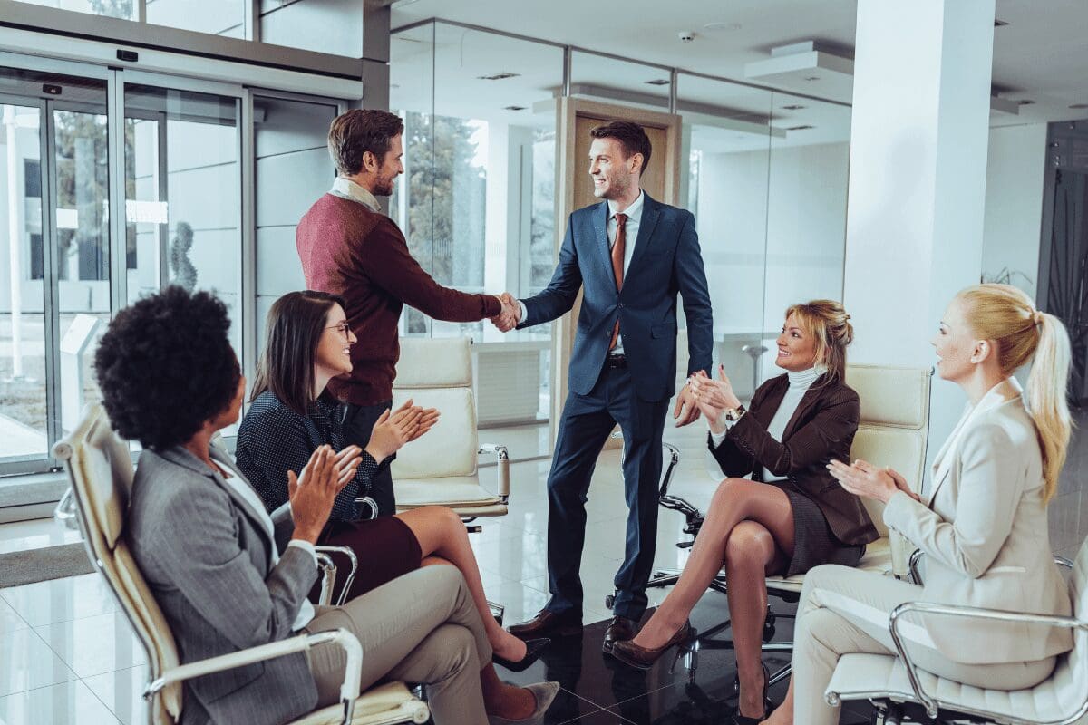 Business team celebrating handshake in meeting